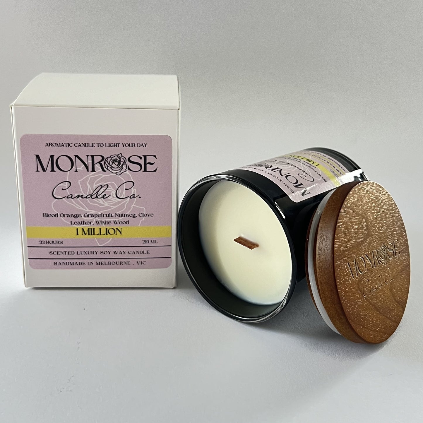 "Side view of a black jar candle with 1 million fragrance and cotton wick, containing 185 grams of soy wax and offering 33 hours of burn time."