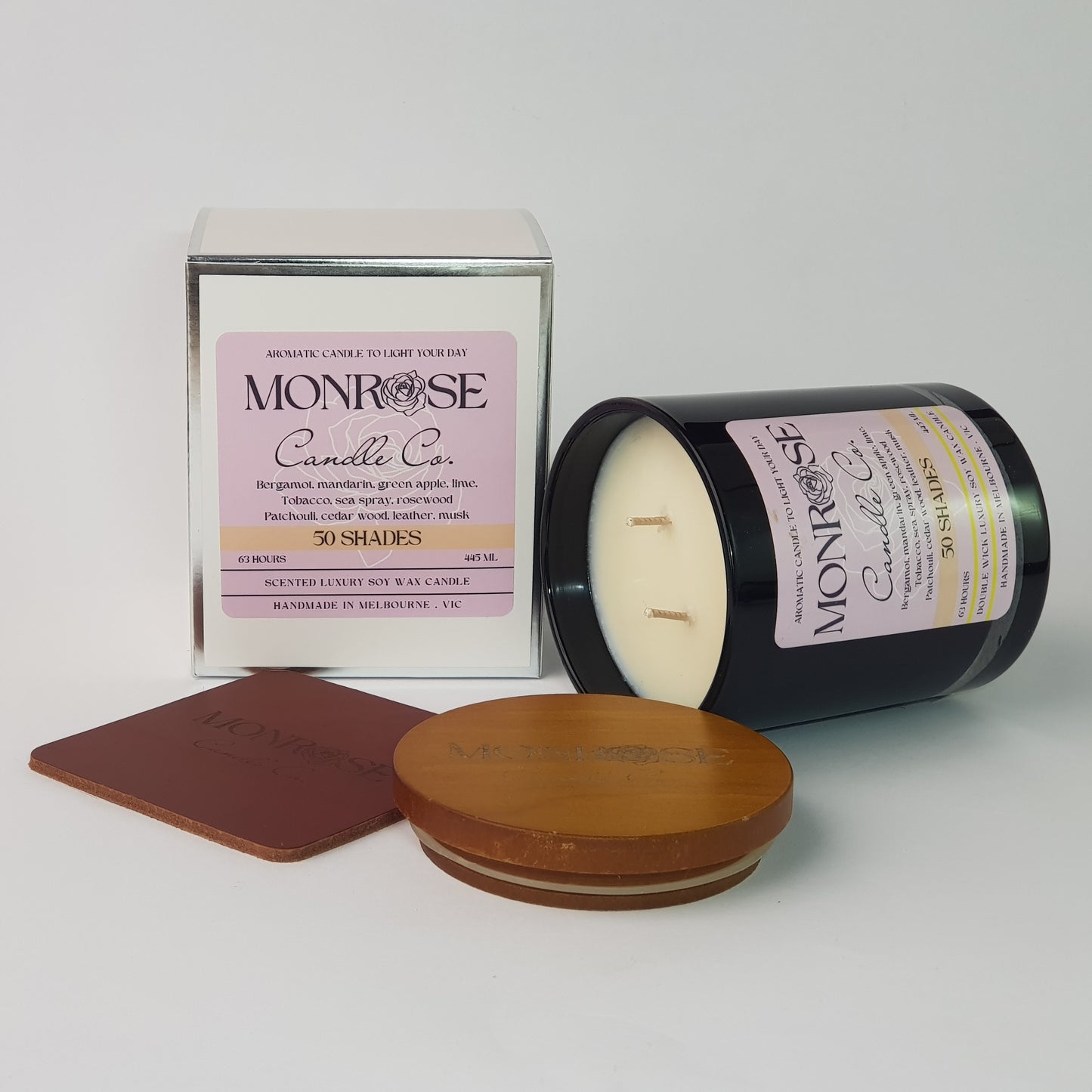 Side view of a black jar candle with "50 Shades" fragrance and a cotton wick, containing 395 grams of soy wax and offering 63 hours of burn time.