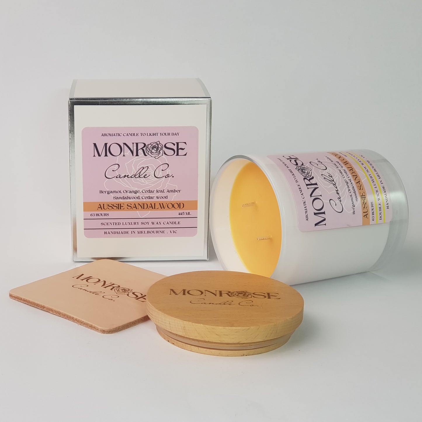 Side view of a white jar candle with "Australian Sandalwood" fragrance and double cotton wick, containing 395 grams of soy wax and offering 63 hours of burn time.