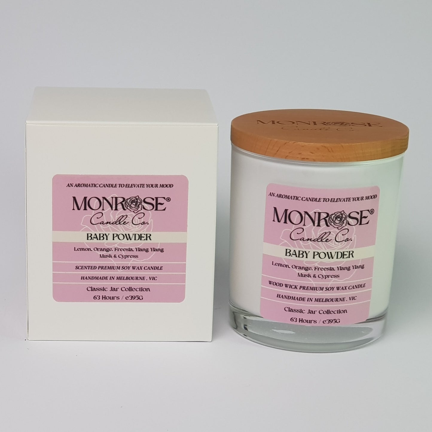 Front view of a white jar candle with "Baby powder" fragrance and a double cotton wicks, containing 395 grams of soy wax and offering 63 hours of burn time.