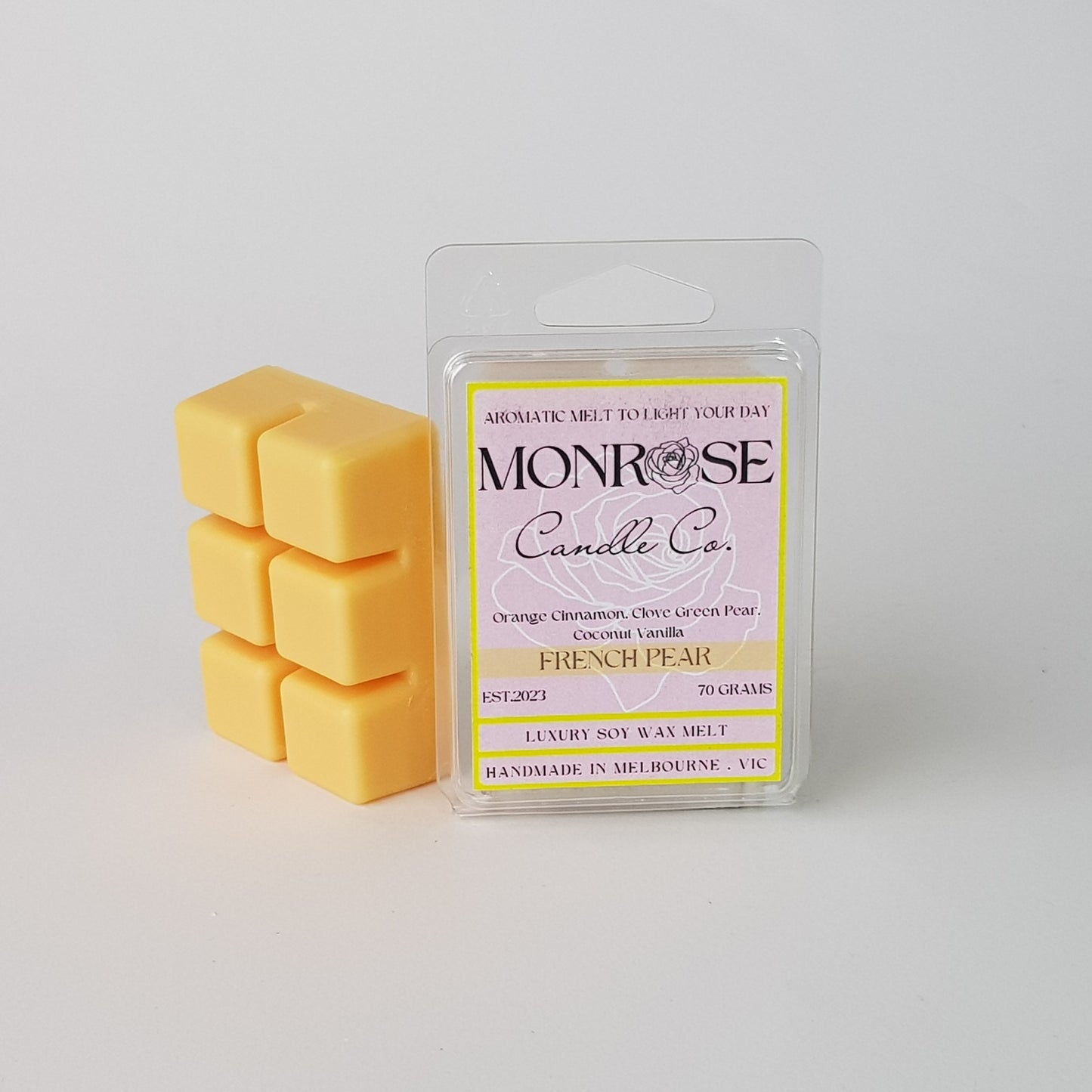 This is the side view of a 6 pack soy wax melt, featuring a light orange color solid wax melt standing on the left of the packaging. The fragrance of the wax melt is "French pear" and contains 70 grams of soy wax and it is hand crafted in Melbourne, Australia.