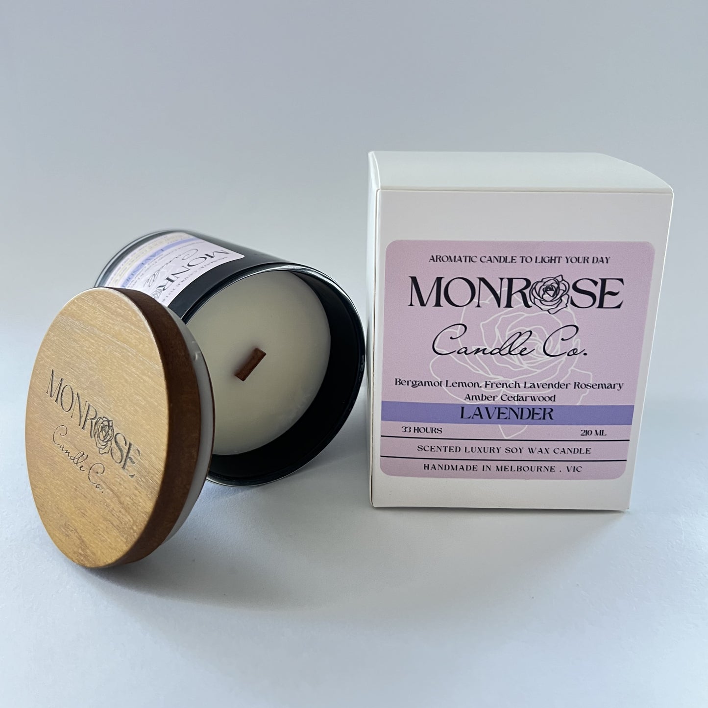 Side view of a black jar candle with "Lavender" fragrance and a wood wick, containing 185 grams of soy wax and offering 33 hours of burn time.