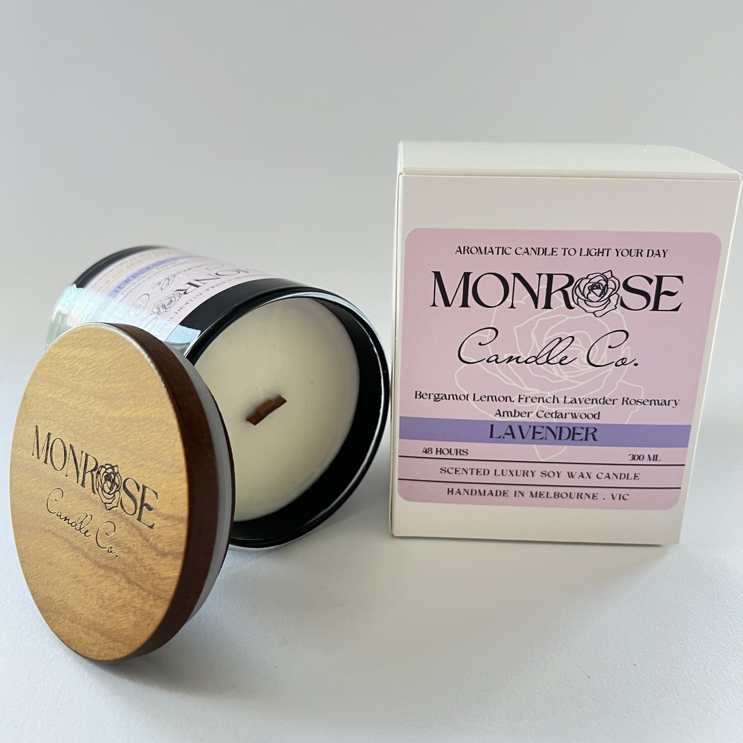 Side view of a black jar candle with "Lavender" fragrance and a wood wick, containing 265 grams of soy wax and offering 48 hours of burn time.