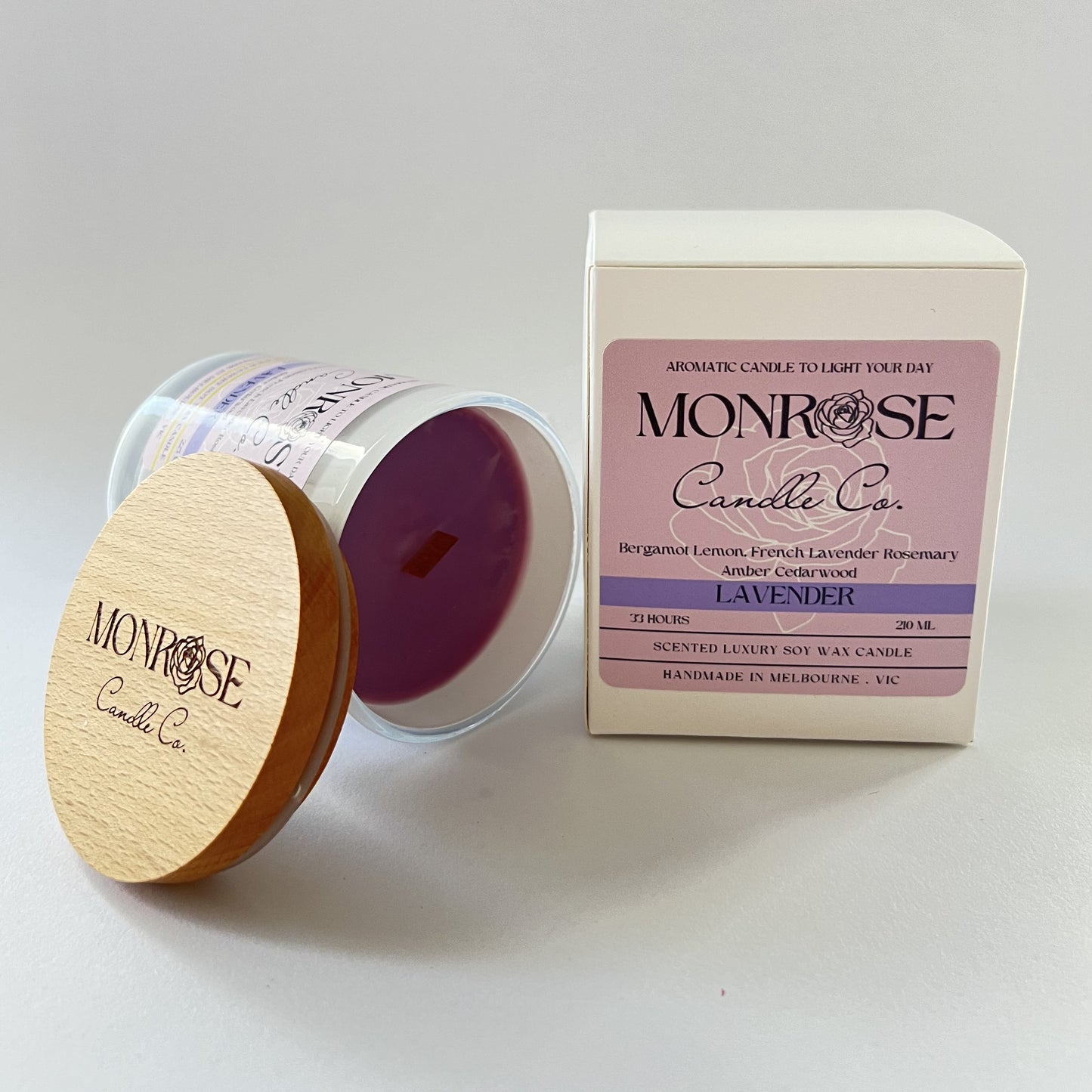 Front view of a white jar candle with "Lavender" fragrance and a wood wick, containing 185 grams of soy wax and offering 33 hours of burn time.