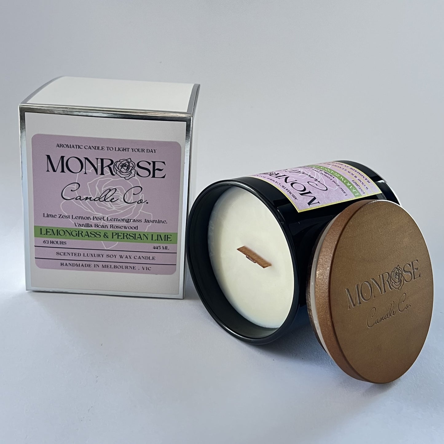 Side view of a black jar candle with "Lemongrass & Persian lime" fragrance and wood wicks, containing 395 grams of soy wax and offering 63 hours of burn time.