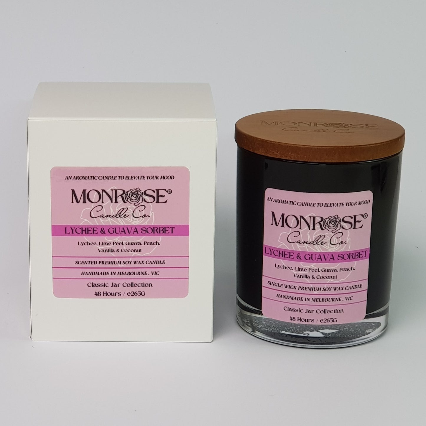 Front view of a container candle with "Lychee & guava sorbet" fragrance in black glass jar and a cotton wick, containing 265 grams of soy wax and offering 48 hours of burn time.