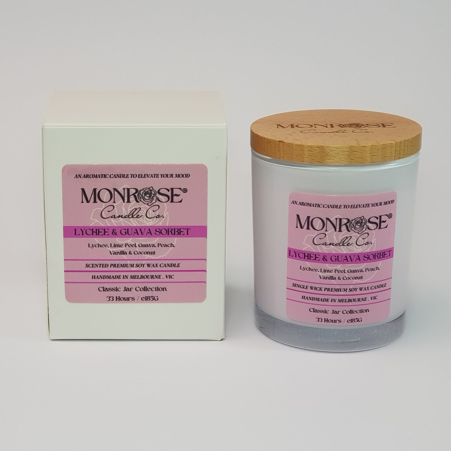 Front view of a container candle with "Lychee & guava sorbet" fragrance in white glass jar and double cotton wicks, containing 185 grams of soy wax and offering 33 hours of burn.