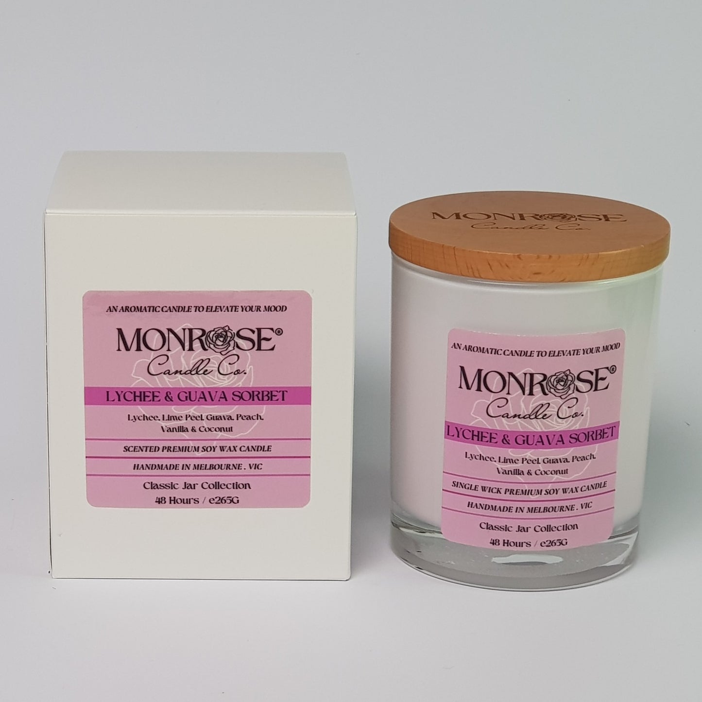 Front view of a container candle with "Lychee & guava sorbet" fragrance in white glass jar and double cotton wicks, containing 265 grams of soy wax and offering 48 hours of burn.