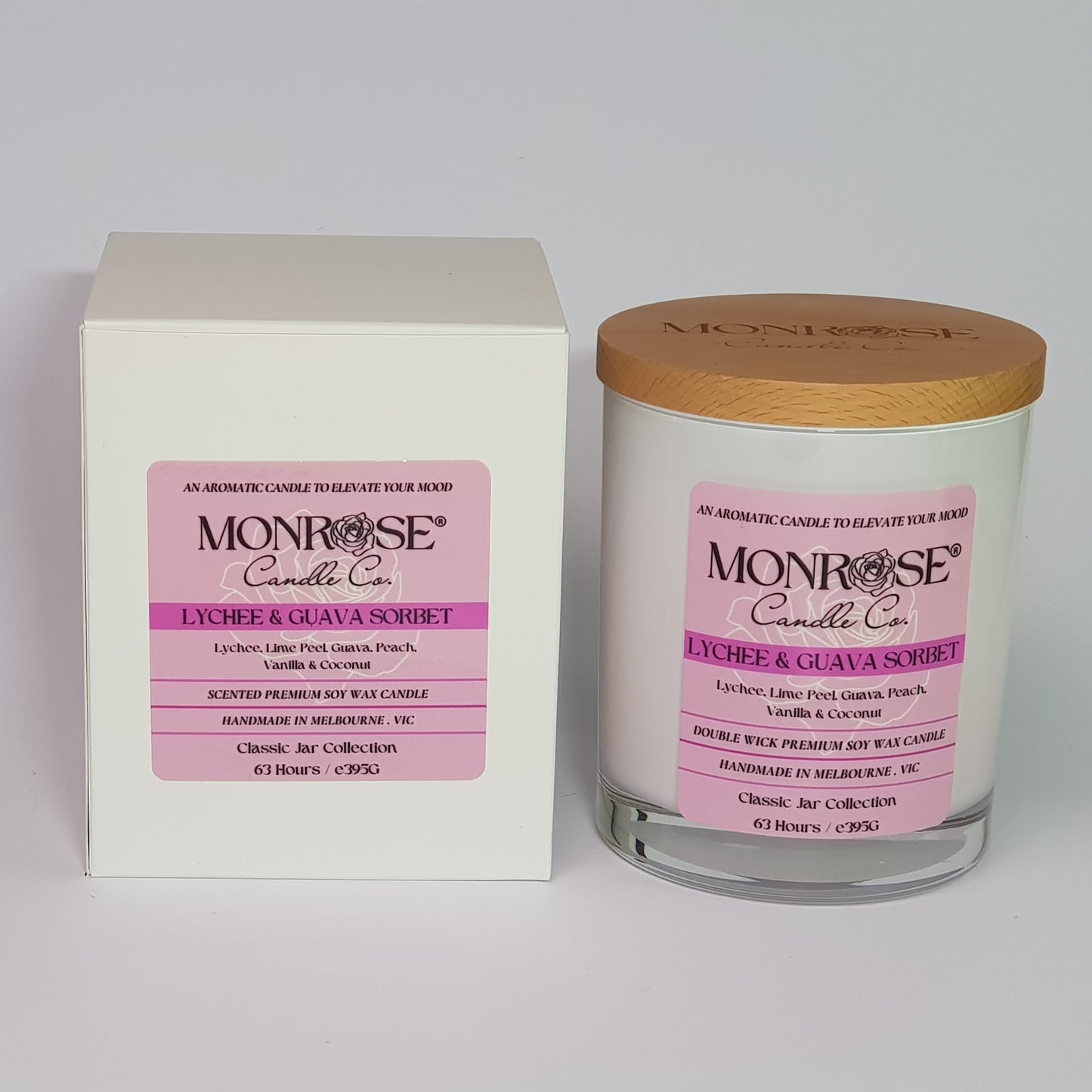 Front view of a container candle with "Lychee & guava sorbet" fragrance in white glass jar and double cotton wicks, containing 395 grams of soy wax and offering 63 hours of burn.