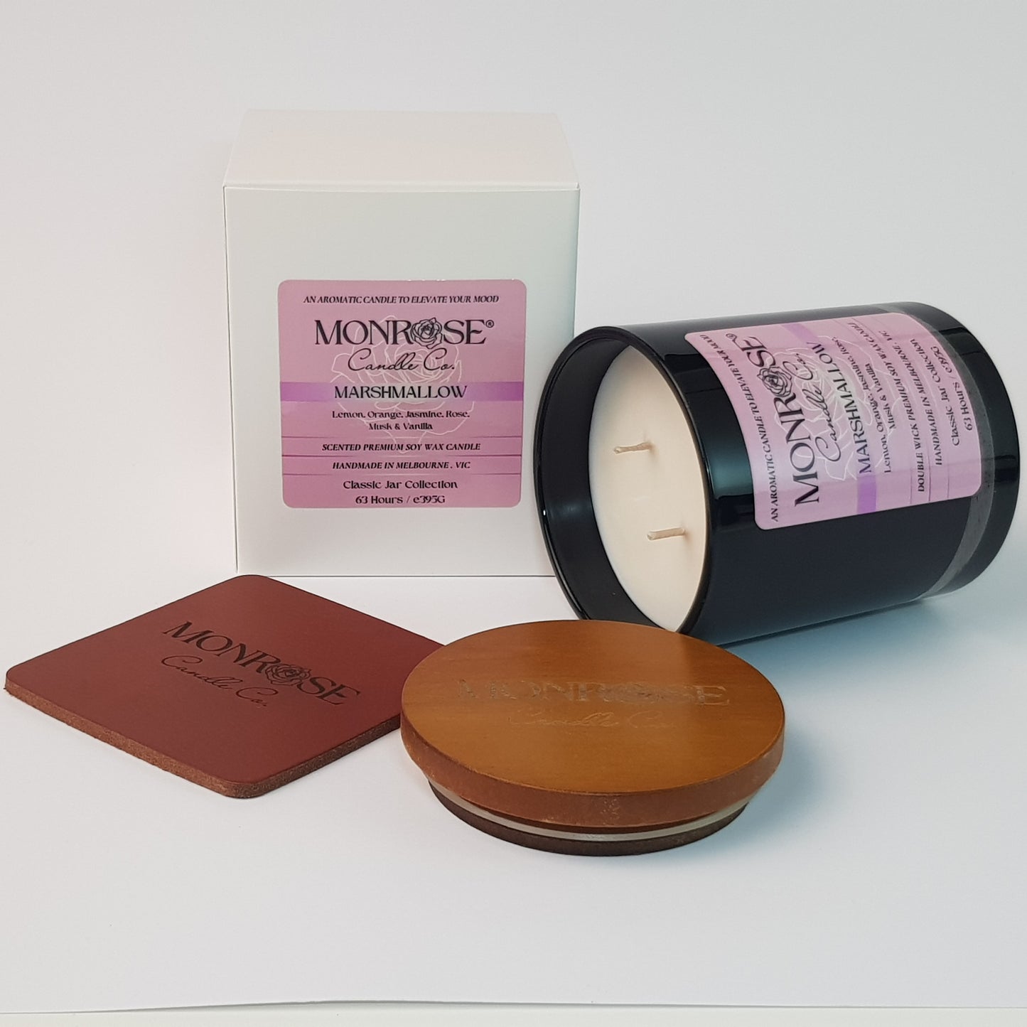 Side view of a black jar candle with "Marshmallow" fragrance and double cotton wicks, containing 395 grams of soy wax and offering 63 hours of burn time.