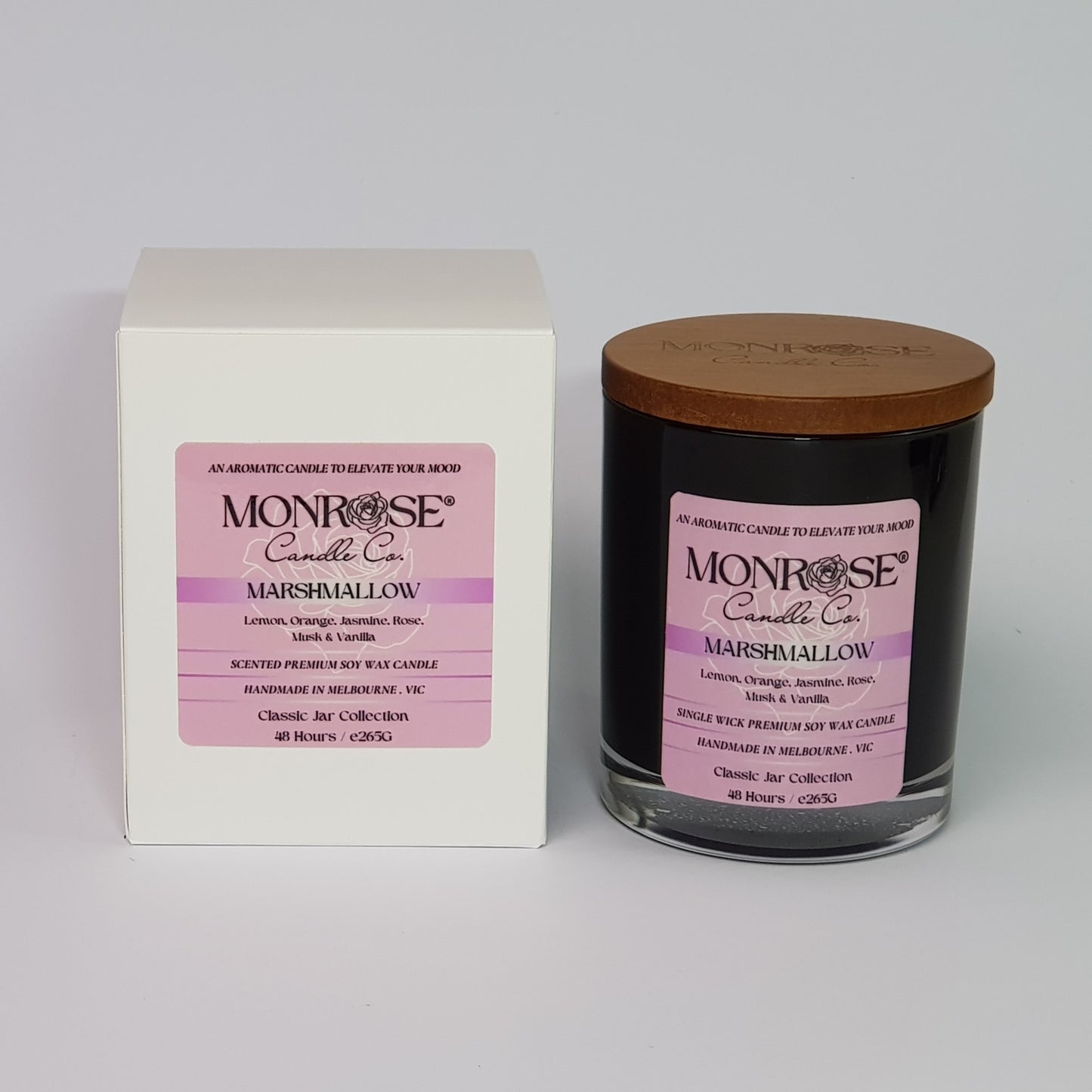 Front view of a container candle with "Marshmallow" fragrance in black glass jar and a cotton wick, containing 265 grams of soy wax and offering 48 hours of burn time.