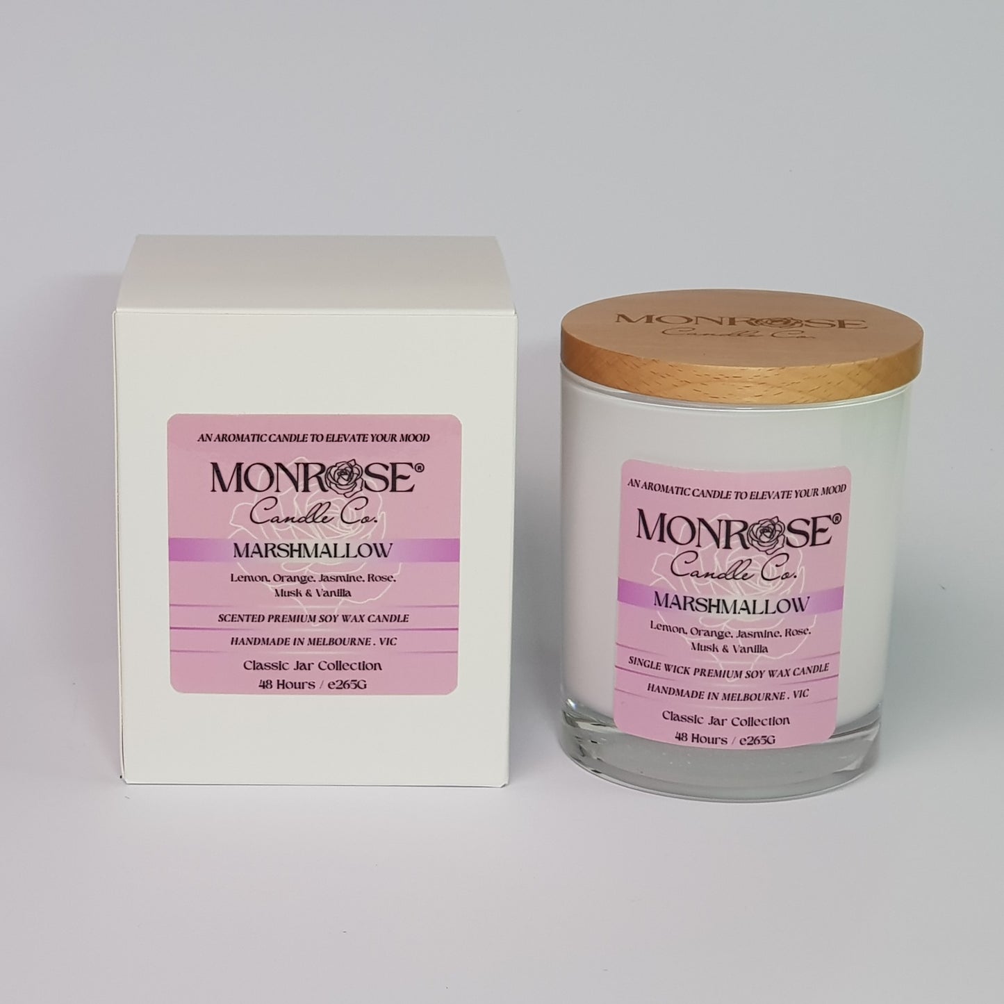 Front view of a container candle with "Marshmallow" fragrance in white glass jar and a cotton wick, containing 265 grams of soy wax and offering 48 hours of burn time.