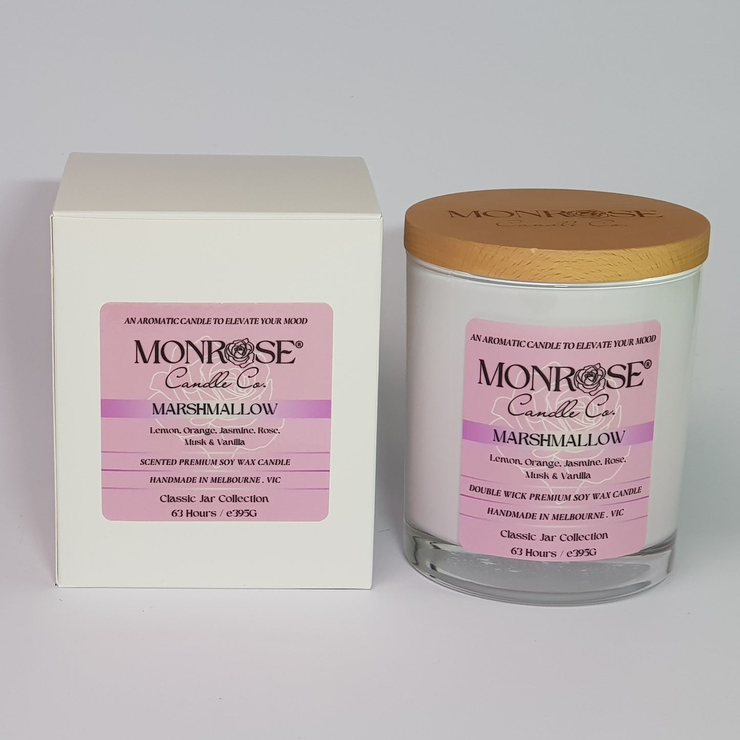 Front view of a container candle with "Marshmallow" fragrance in white glass jar and a cotton wick, containing 395 grams of soy wax and offering 63 hours of burn time.