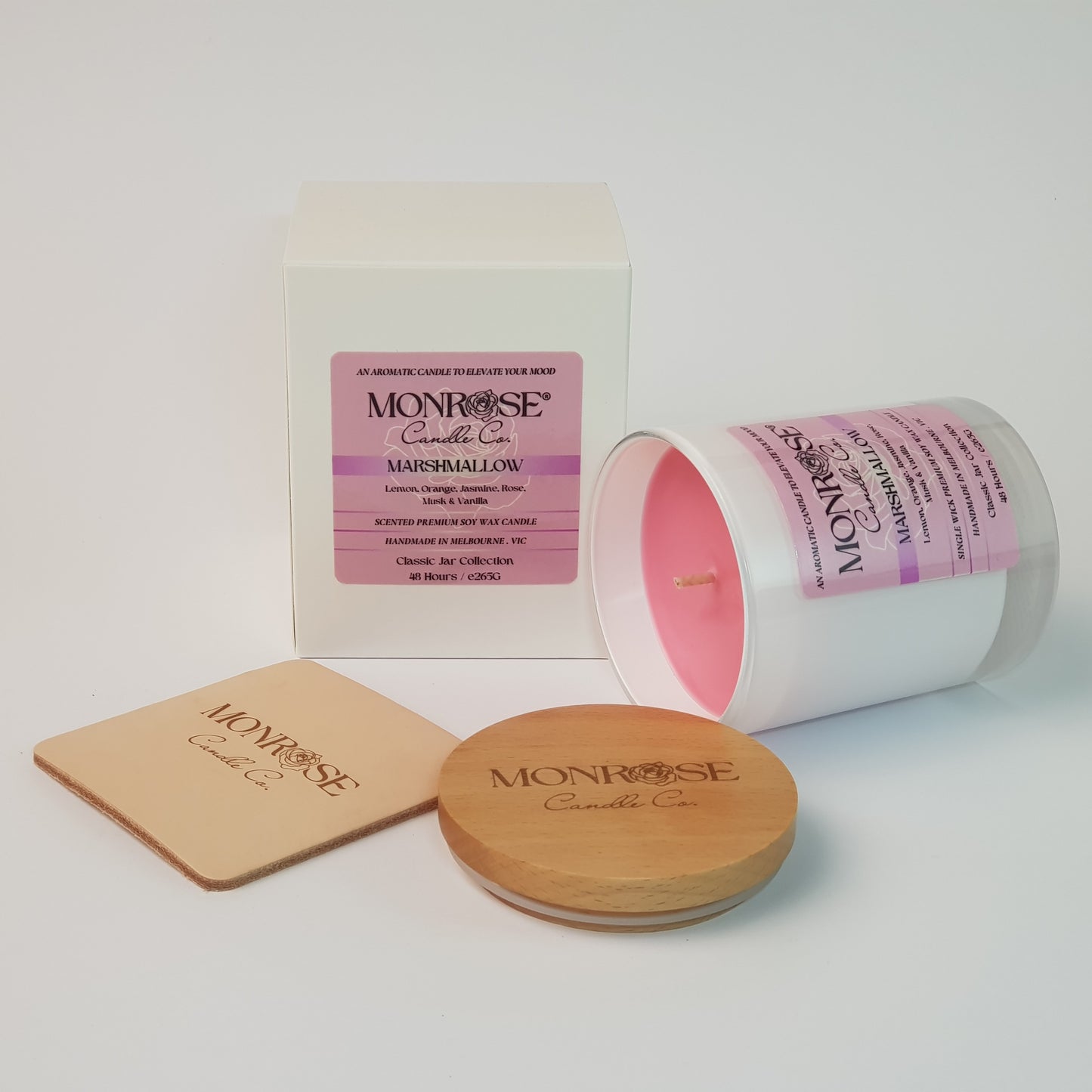 Side view of a container candle with "Marshmallow" fragrance in white glass jar and a cotton wick, containing 265 grams of soy wax and offering 48 hours of burn time.