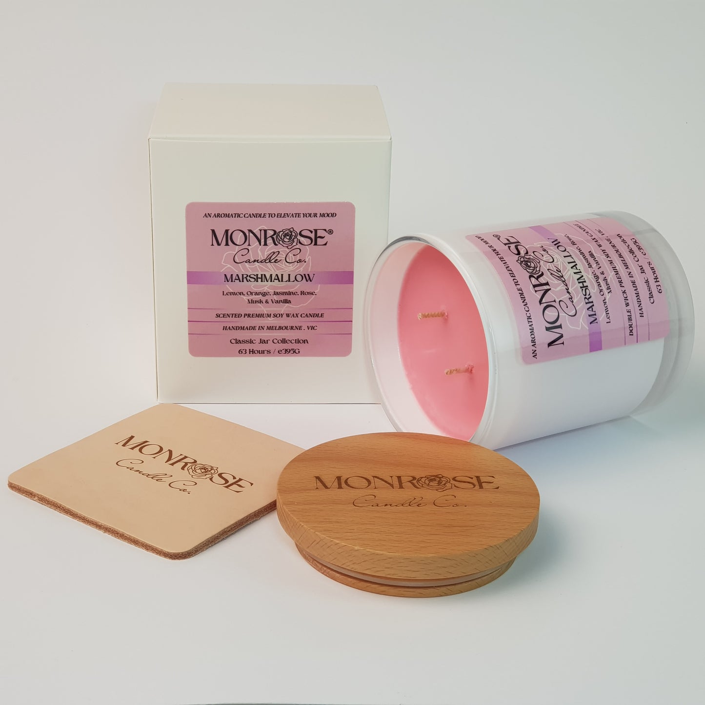 Side view of a white jar candle with "Marshmallow" fragrance and double cotton wicks, containing 395 grams of soy wax and offering 63 hours of burn time.
