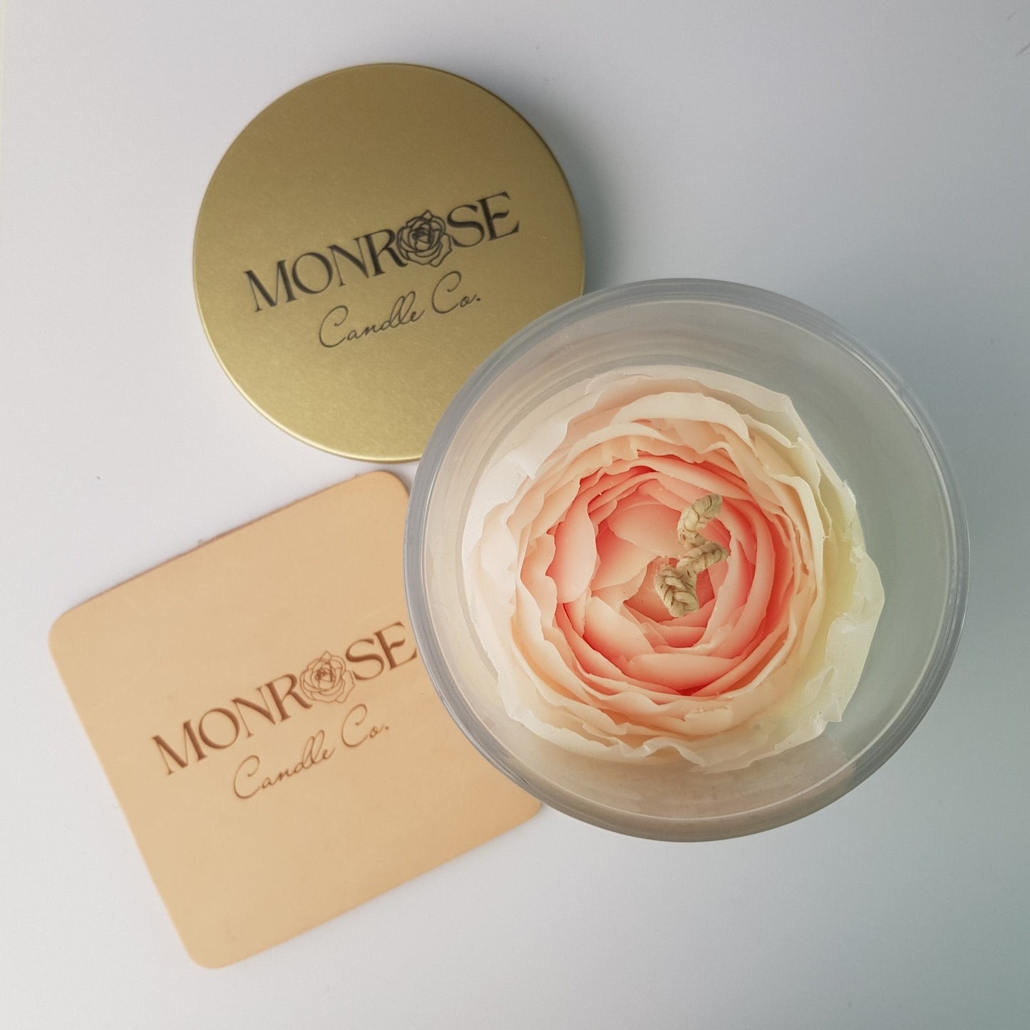 Top view of a Rose Candle as No.2 in a clear jar with "Miss Dior" fragrance and a cotton wick, containing 365 grams of bees & soy wax and offering 56 hours of burn time.