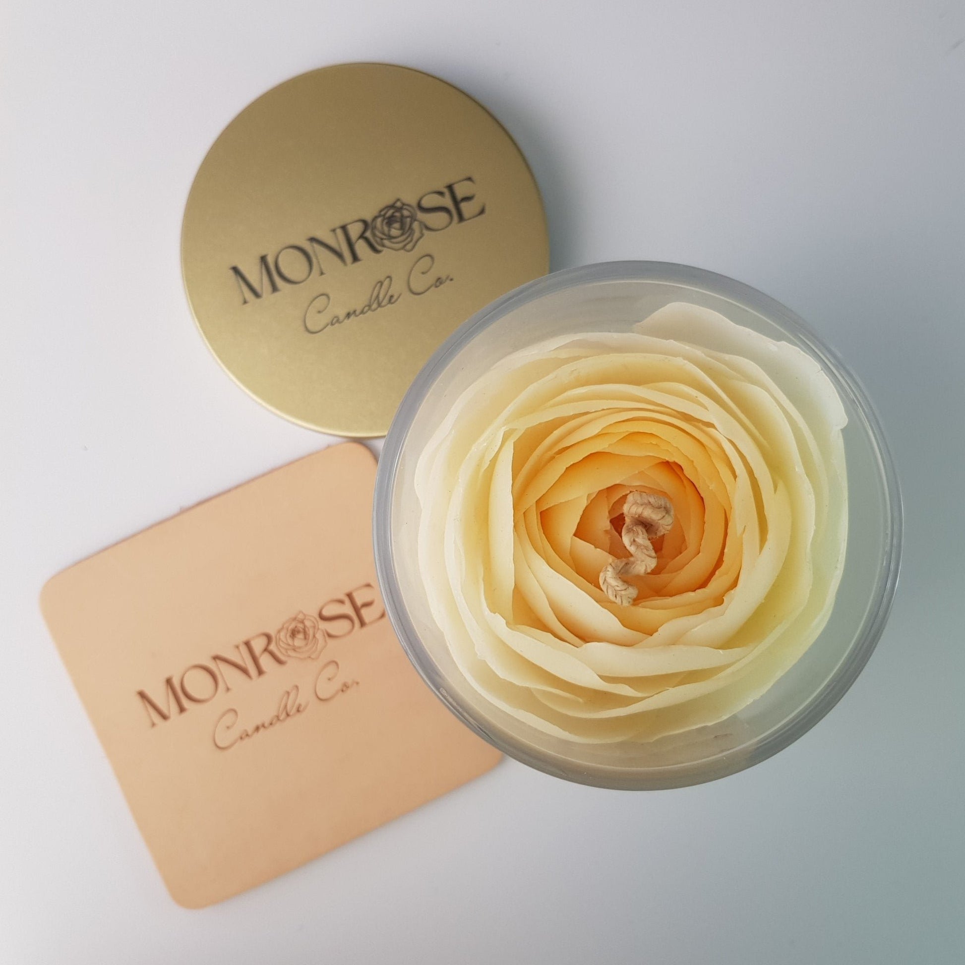 "Top view of a Rose candle in clear glass jar with "1 million fragrance" and a cotton wick, containing 360 grams of bees & soy wax and offering 56 hours of burn time."