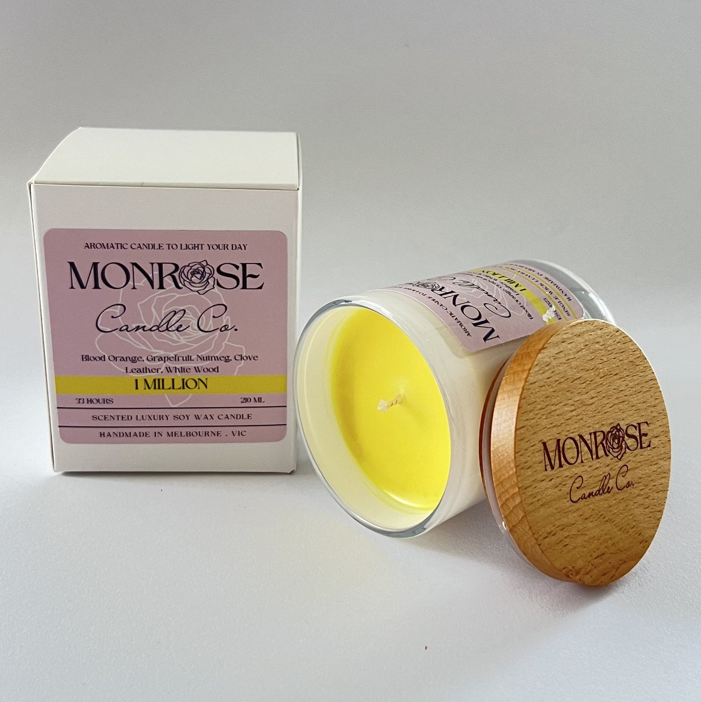 "Side view of a white jar candle with 1 million fragrance and a cotton wick, containing 185 grams of soy wax and offering 33 hours of burn time."