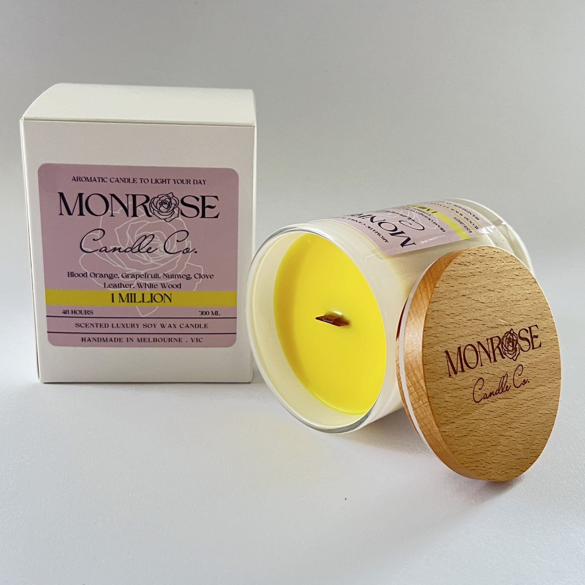 Side view of a white jar candle with "1 million" fragrance and wood wick, containing 265 grams of soy wax and offering 48 hours of burn time.
