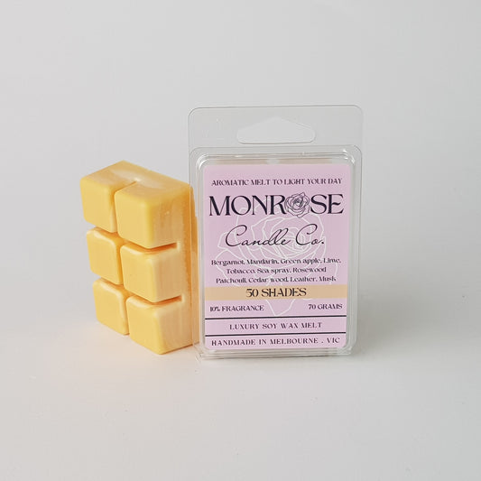 "This is the side view of a 6 pack soy wax melt, featuring a orange solid wax melt standing on the left of the packaging. The fragrance of the wax melt is 50 shades and contains 70 grams of soy wax and it is hand crafted in Melbourne, Australia."