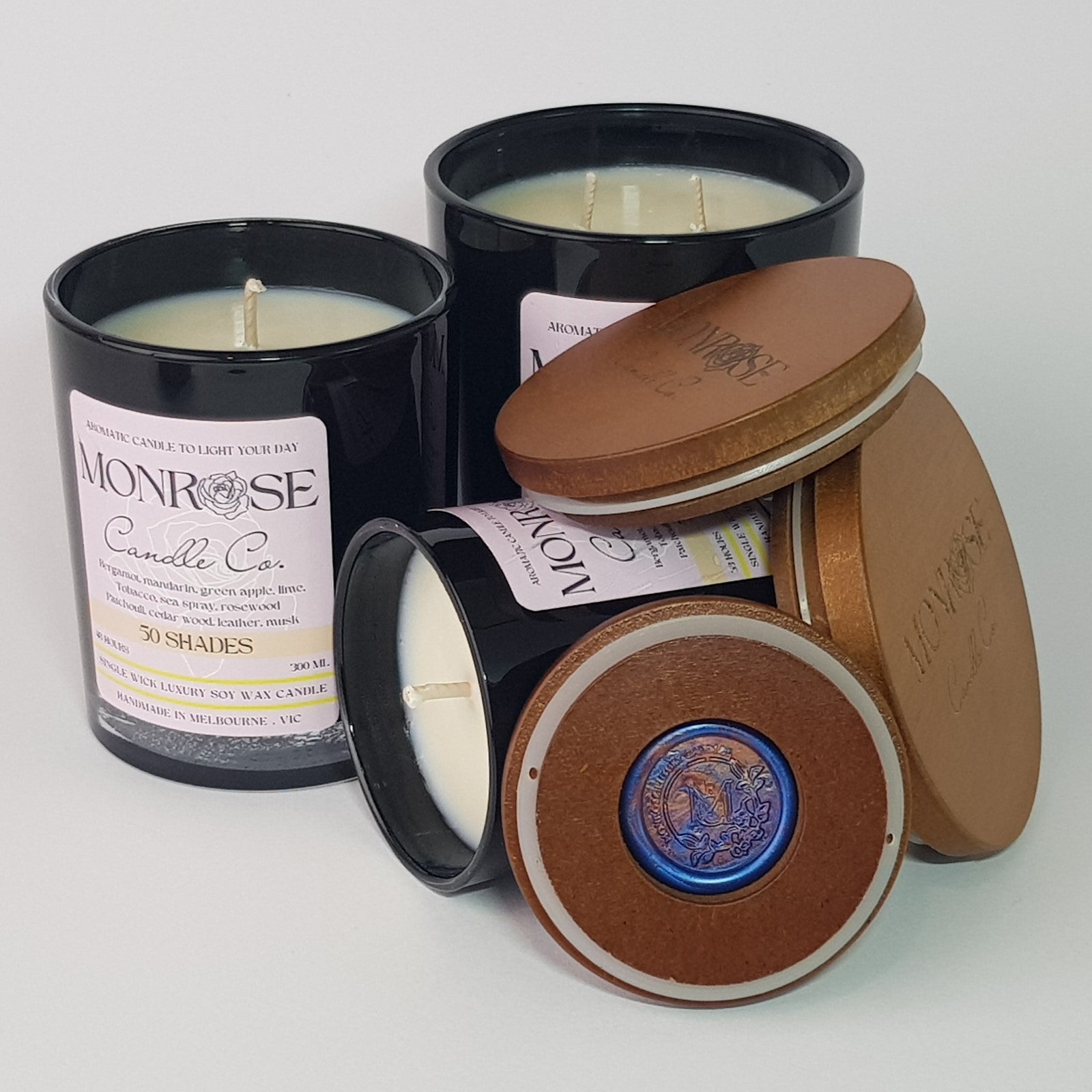 Front view of a black jar candle collection with "50 Shades" fragrance and a cotton wick.