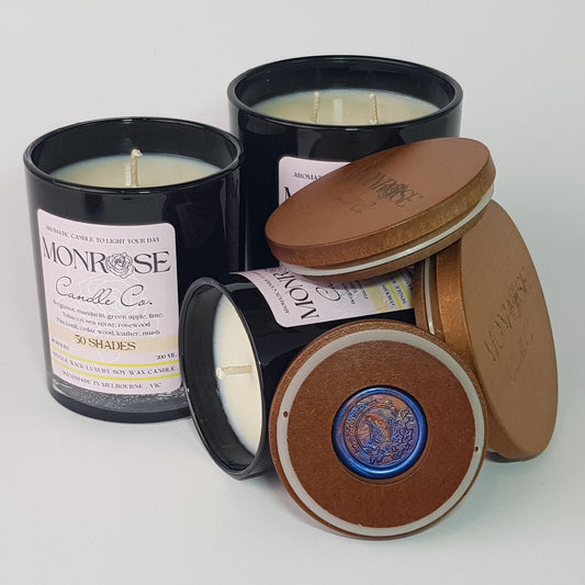 Front view of a black jar candle collection with "50 Shades" fragrance and a cotton wick.