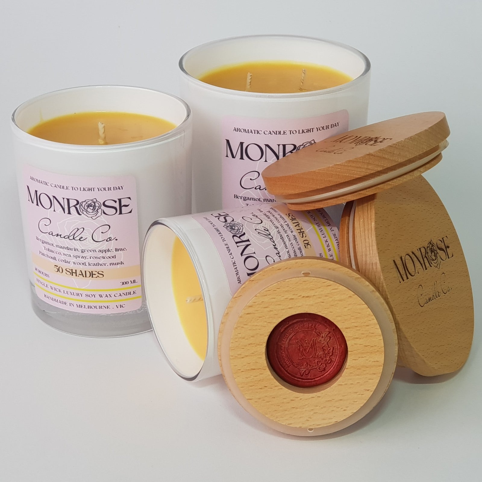 Front view of a White jar candle collection with "50 Shades" fragrance and cotton wicks.