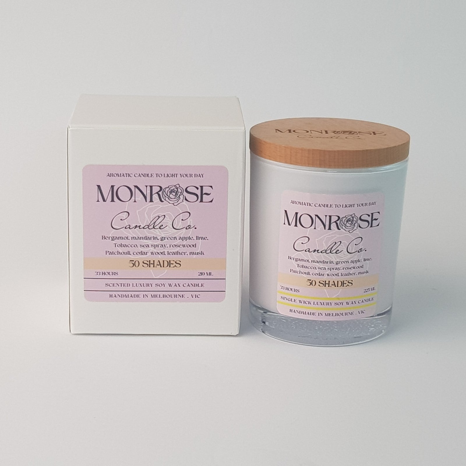 Front view of a white jar candle with "50 Shades" fragrance and a cotton wick, containing 185 grams of soy wax and offering 33 hours of burn time.