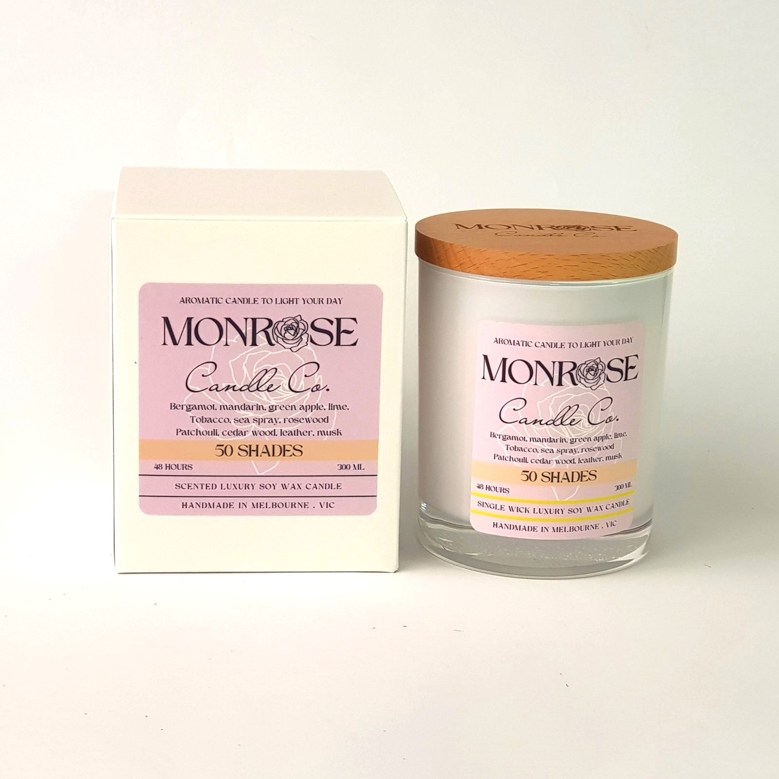 Front view of a white jar candle with "50 Shades" fragrance and a cotton wick, containing 265 grams of soy wax and offering 48 hours of burn time.
