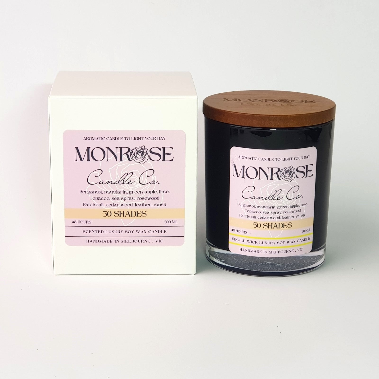 Front view of a black jar candle with "50 Shades" fragrance and a cotton wick, containing 265 grams of soy wax and offering 48 hours of burn time.