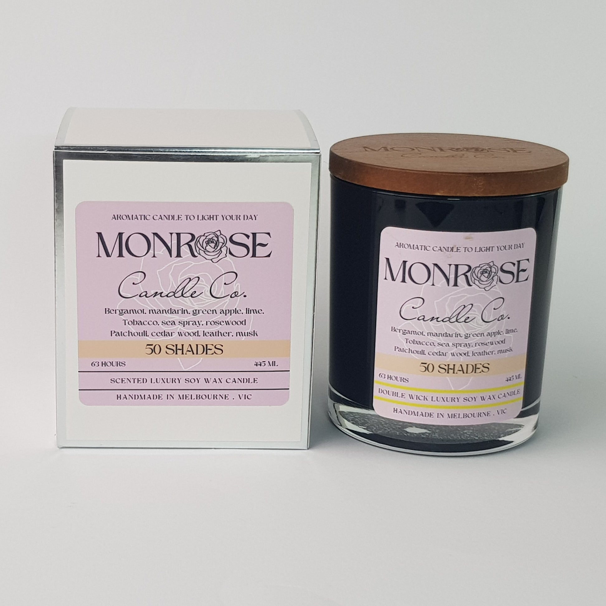 Front view of a black jar candle with "50 Shades" fragrance and a cotton wick, containing 395 grams of soy wax and offering 63 hours of burn time.