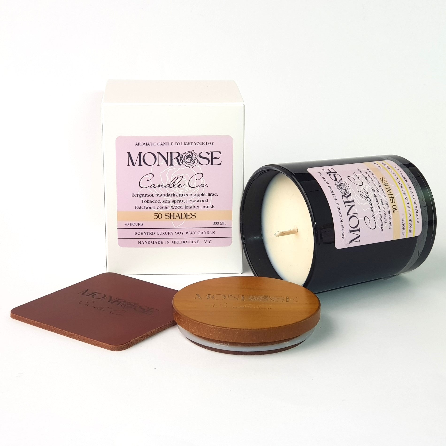 Side view of a black jar candle with "50 Shades" fragrance and a cotton wick, containing 265 grams of soy wax and offering 48 hours of burn time.