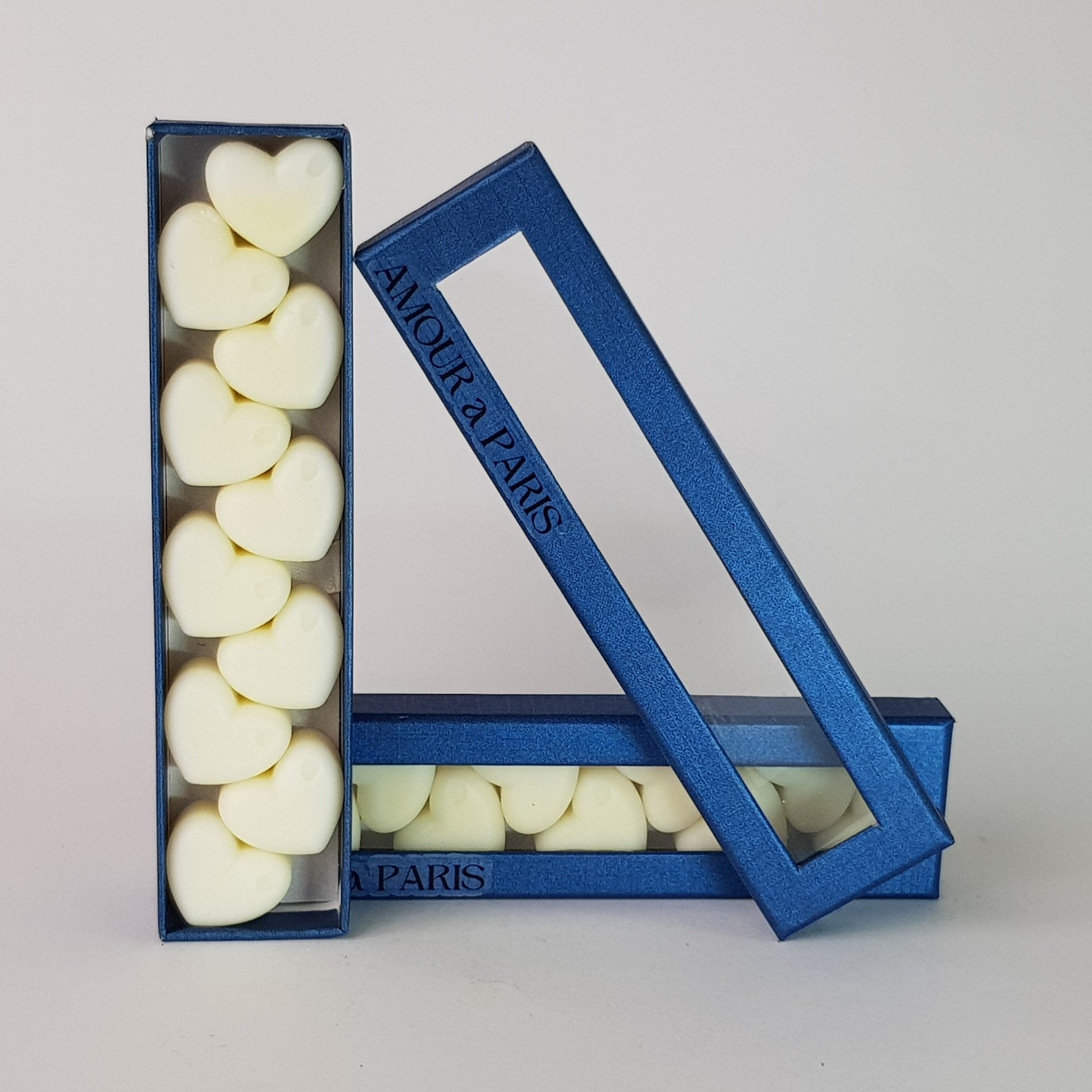 "This is the front view of heart shaped soy wax melts, featuring 10 solid wax melts inside a rectangular blue box. The fragrance of the wax melt is  "Amour A Paris" and it contains 76 grams of soy wax and it is hand crafted in Melbourne, Australia."