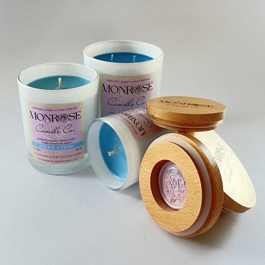 Front view of white jar candle collection with "Amour a Paris" fragrance and cotton wick.
