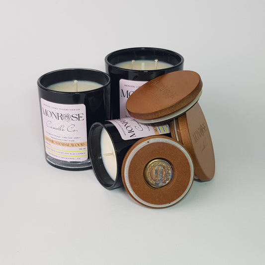 Front view of the black jar candle collection with "Australian Sandalwood" fragrance and cotton wicks.