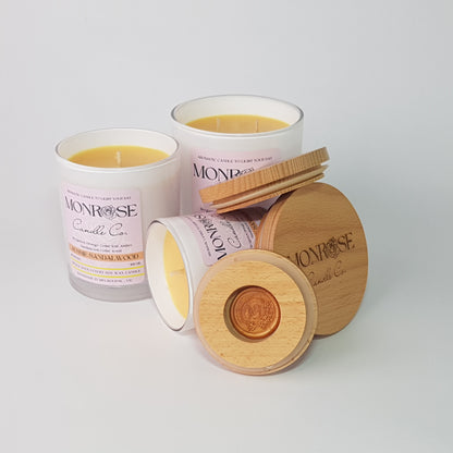 Front view of the black jar candle collection with "Australian Sandalwood" fragrance and cotton wicks.