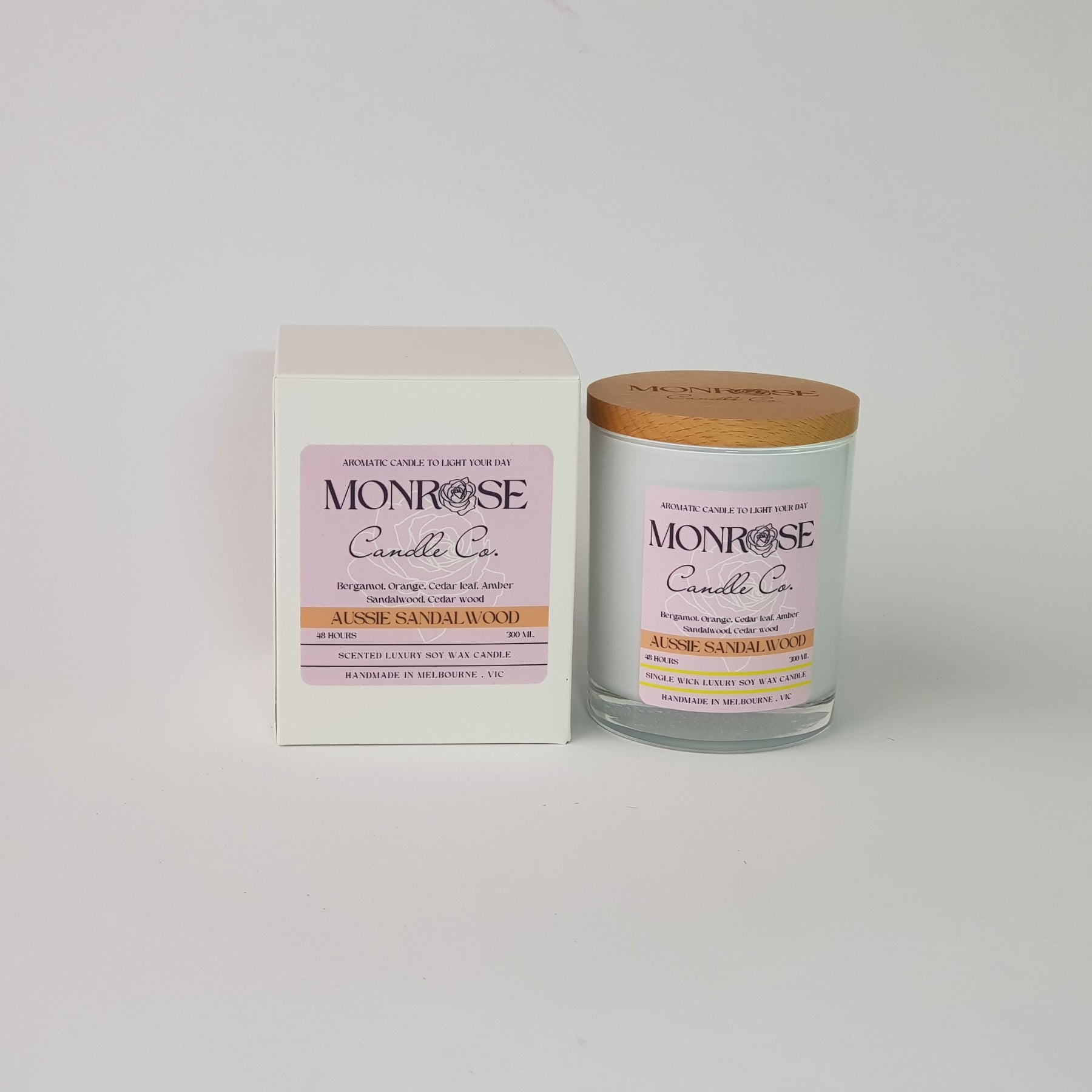 Front view of a container candle with "Australian Sandalwood" fragrance in white glass jar and a cotton wick, containing 265 grams of soy wax and offering 48 hours of burn time.