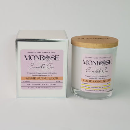 Front view of a container candle with "Australian Sandalwood" fragrance in white glass jar and a cotton wick, containing 395 grams of soy wax and offering 63 hours of burn time.