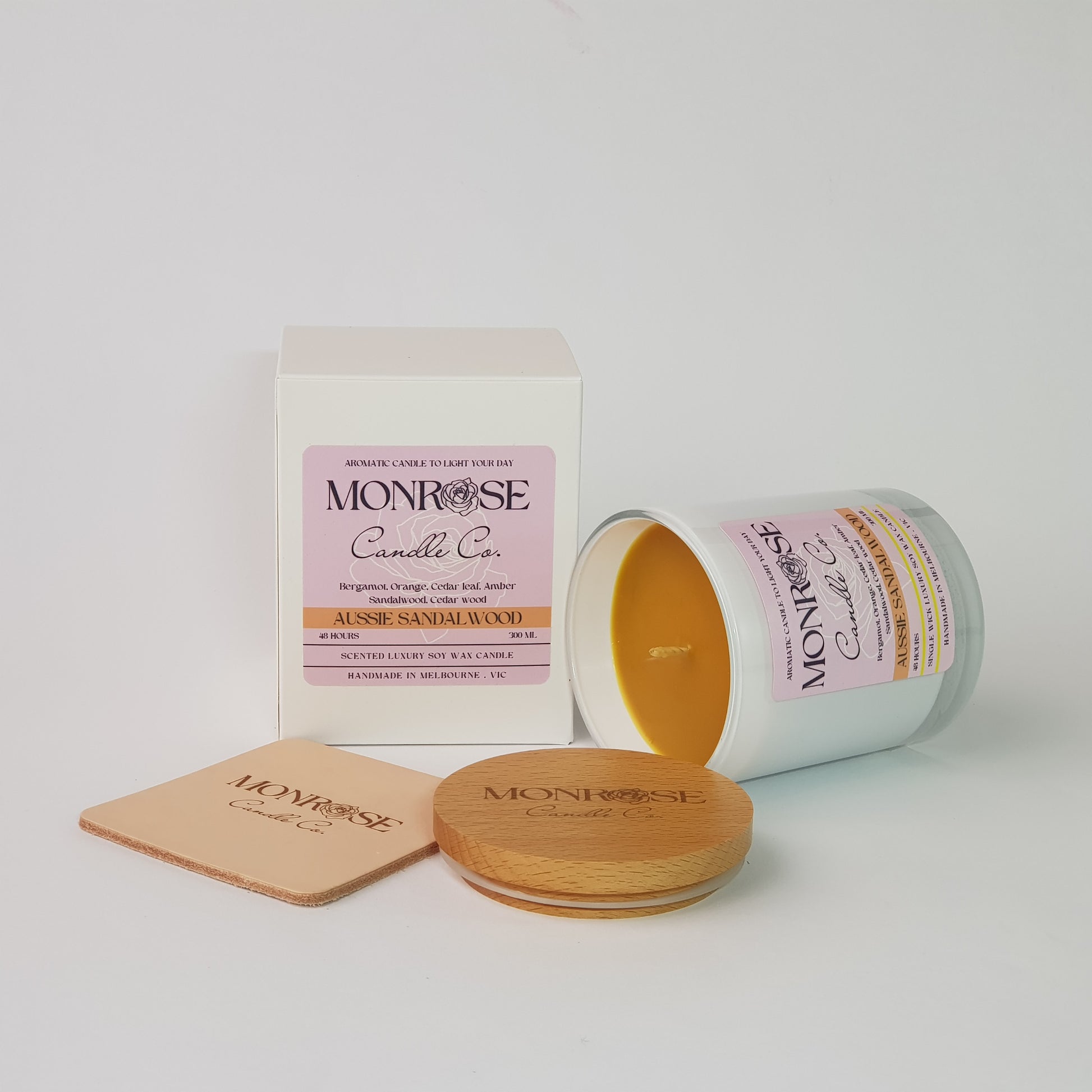 Side view of a container candle with "Australian Sandalwood" fragrance in white glass jar and a cotton wick, containing 265 grams of soy wax and offering 48 hours of burn time.