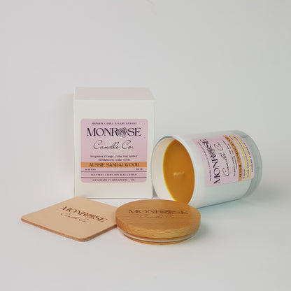Side view of a container candle with "Australian Sandalwood" fragrance in white glass jar and a cotton wick, containing 265 grams of soy wax and offering 48 hours of burn time.