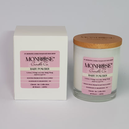 Front view of a white jar candle with "Baby powder" fragrance and a cotton wick, containing 265 grams of soy wax and offering 48 hours of burn time.