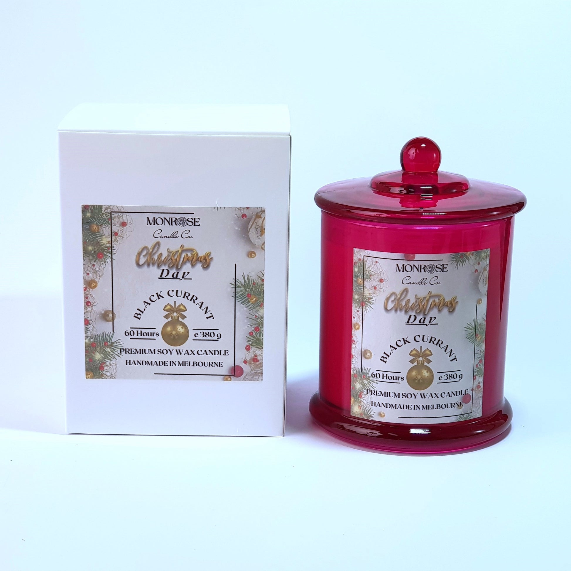 Front view of a red jar candle with 
"Black Currant" fragrance and a cotton wick, containing 380 grams of soy wax and offering 60 hours of burn time.