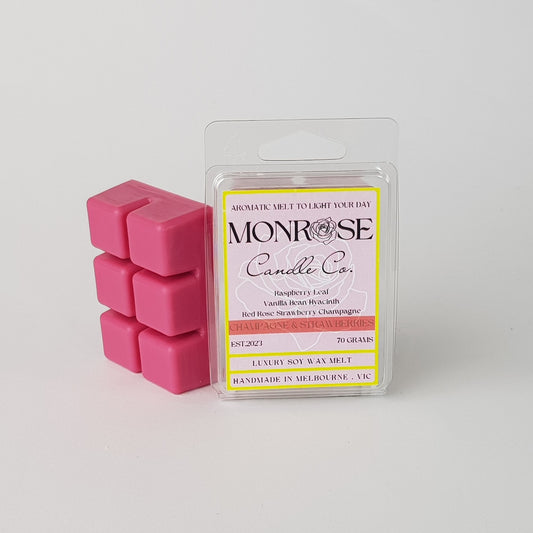 This is the side view of a 6 pack soy wax melt, featuring a red solid wax melt standing on the left of the packaging. The fragrance of the wax melt is "Champagne and strawberries" and contains 70 grams of soy wax and it is hand crafted in Melbourne, Australia.