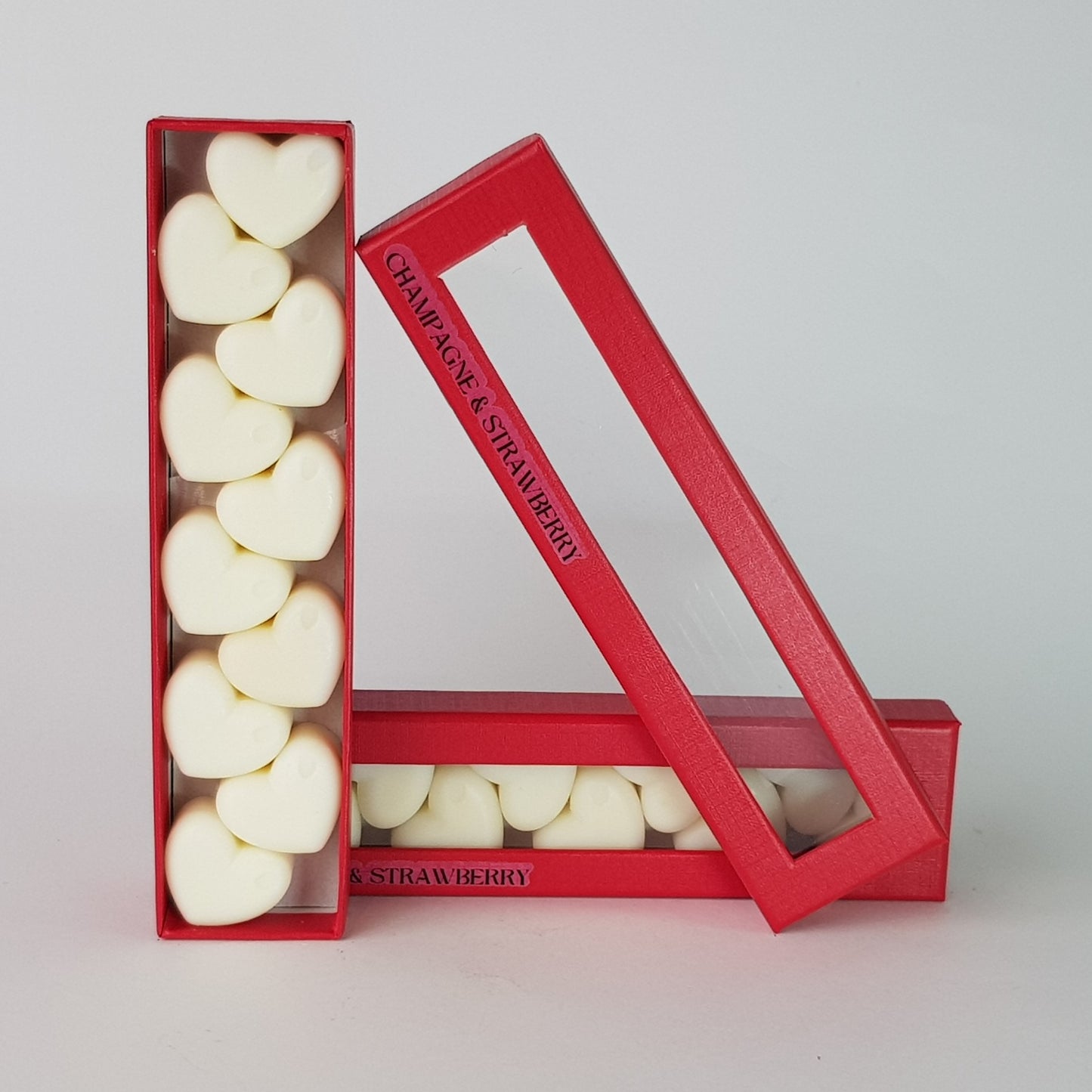 This is the front view of heart shaped soy wax melts, featuring 10 solid wax melts inside a rectangular box. The fragrance of the wax melt is  "Champagne and strawberry" and it contains 76 grams of soy wax and it is hand crafted in Melbourne, Australia.