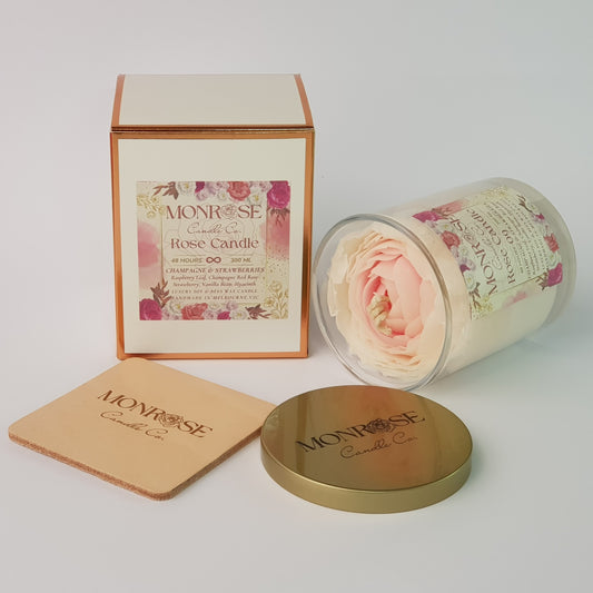 Side view of a Rose Candle No.9 in a clear jar with "Champagne & strawberries" fragrance and cotton wick, containing 365 grams of soy wax and offering 56 hours of burn time.