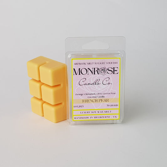 This is the side view of a 6 pack soy wax melt, featuring a light orange color  solid wax melt standing on the left of the packaging. The fragrance of the wax melt is "French pear" and contains 70 grams of soy wax and it is hand crafted in Melbourne, Australia.