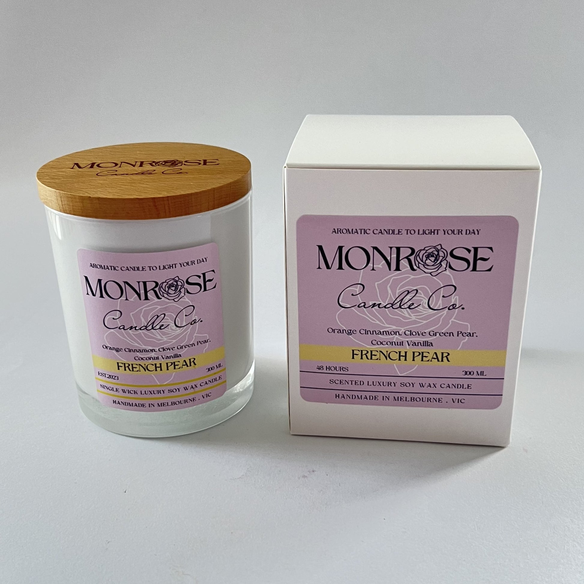 Front view of a white jar candle with "French pear" fragrance and a cotton wick, containing 265 grams of soy wax and offering 48 hours of burn time.