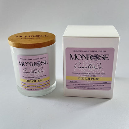 Front view of a white jar candle with "French pear" fragrance and a cotton wick, containing 265 grams of soy wax and offering 48 hours of burn time.