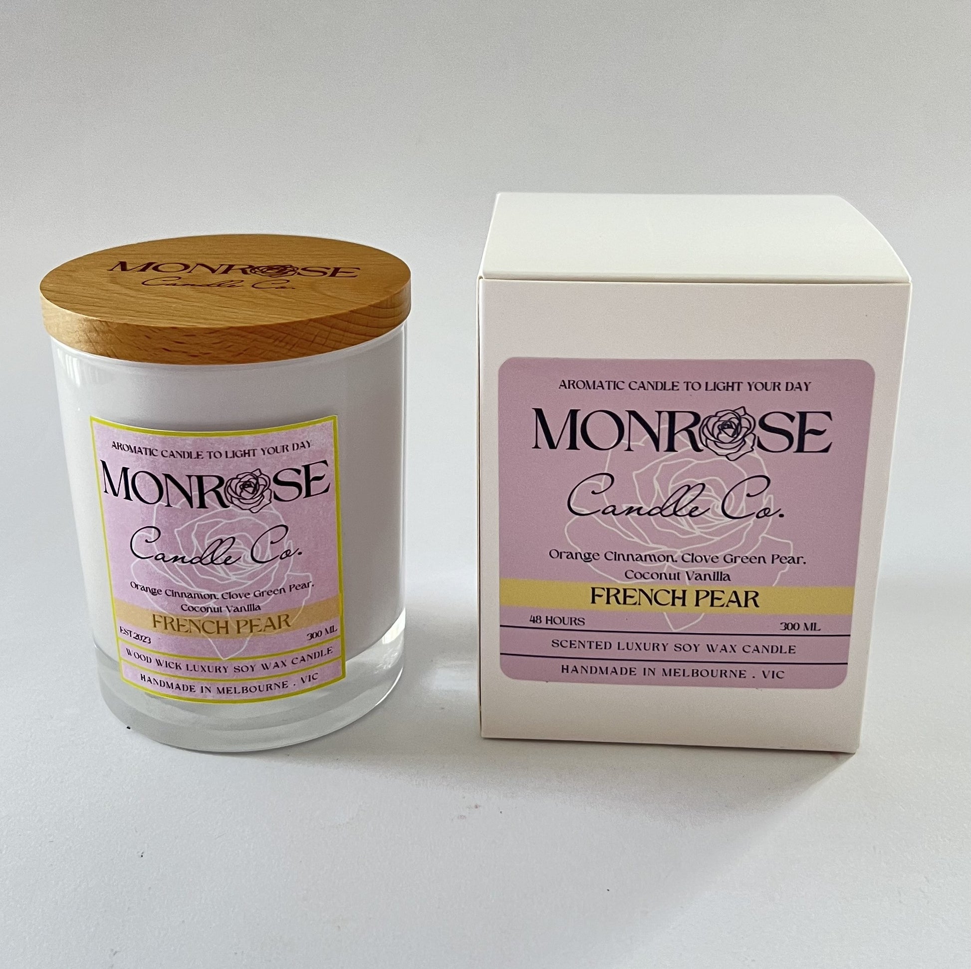Front view of a white jar candle with "French pear" fragrance and double cotton wicks, containing 265 grams of soy wax and offering 48 hours of burn time.