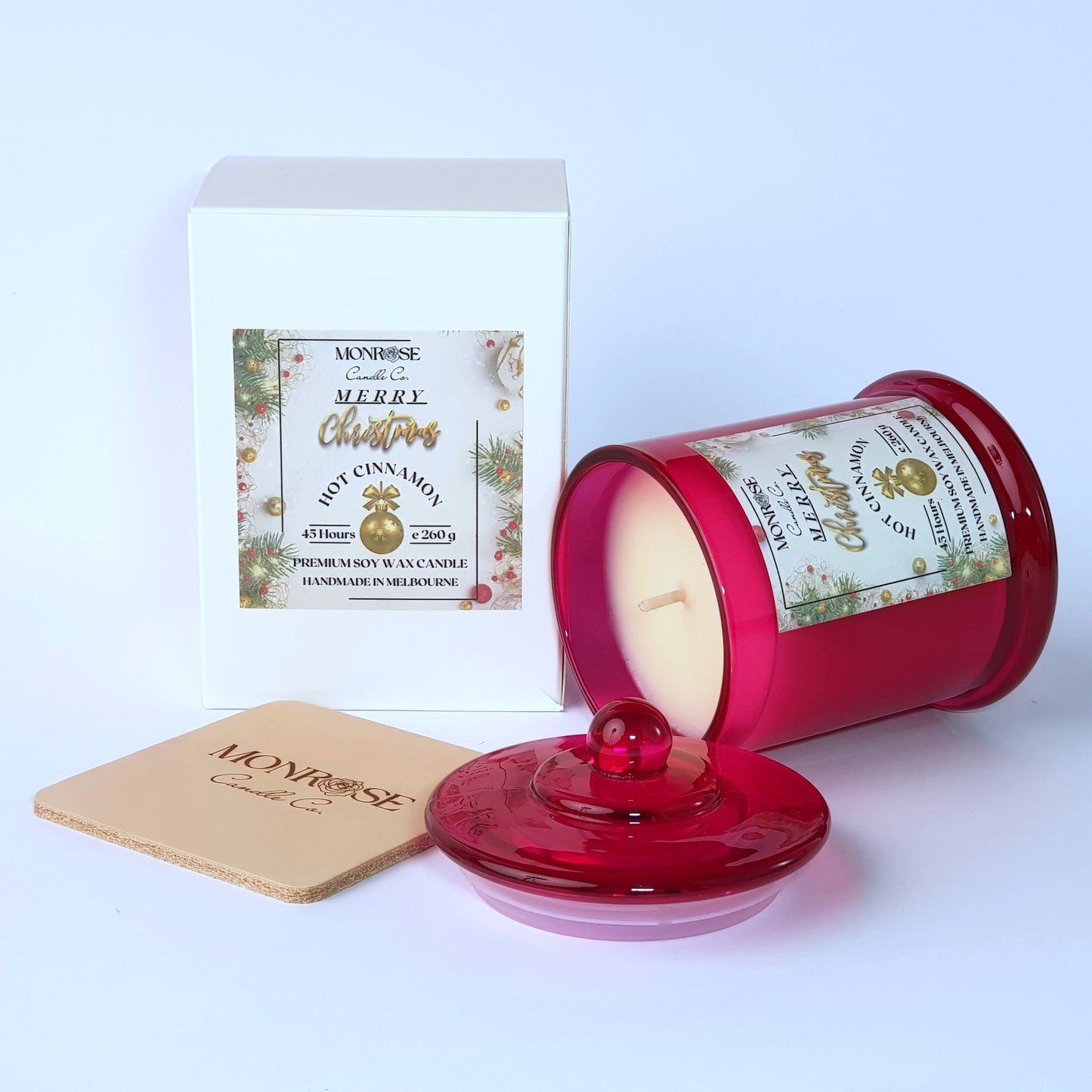 Side view of a red jar candle with 
"Xmas Pudding" fragrance and a cotton wick, containing 260 grams of soy wax and offering 45 hours of burn time.